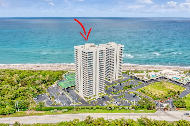 drone / aerial view with a water view and a view of the beach