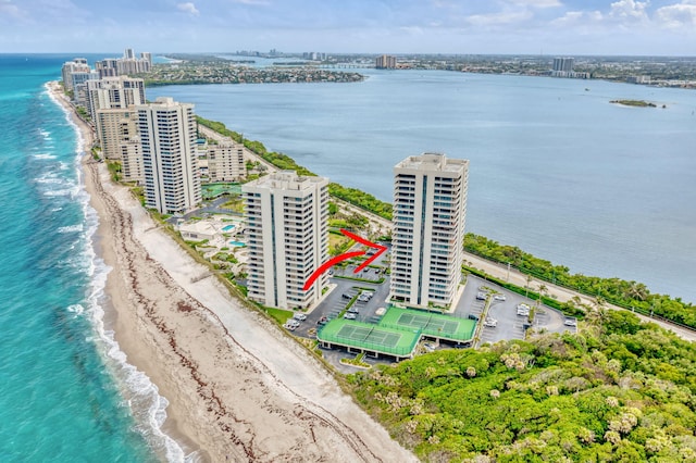drone / aerial view with a view of city, a view of the beach, and a water view