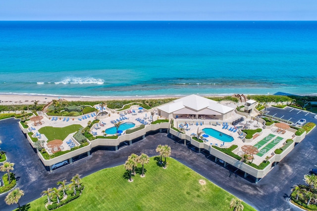 drone / aerial view featuring a water view and a beach view