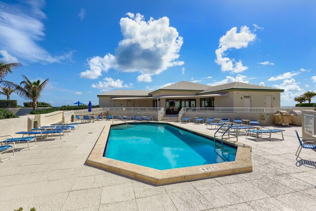 community pool featuring a patio area and fence