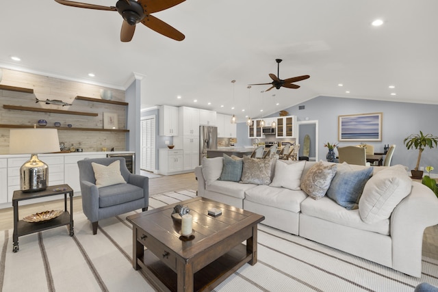 living room with a ceiling fan, recessed lighting, lofted ceiling, and bar area