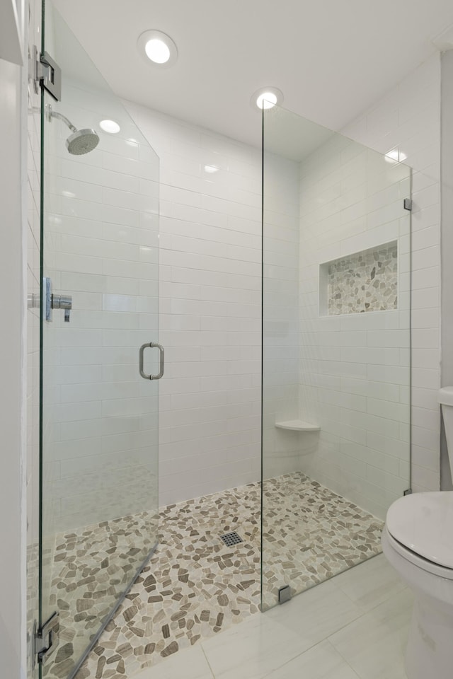 full bathroom featuring toilet, a shower stall, tile patterned floors, and recessed lighting