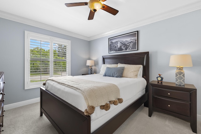 bedroom featuring light carpet, ornamental molding, baseboards, and a ceiling fan