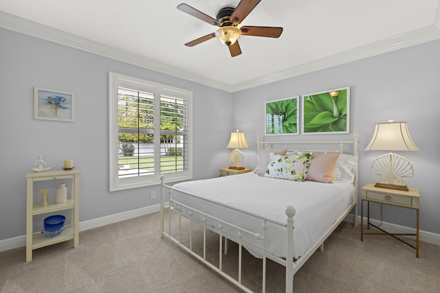 carpeted bedroom with ornamental molding, baseboards, and a ceiling fan