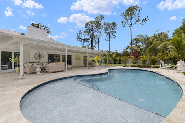 outdoor pool with an outdoor hangout area and a patio