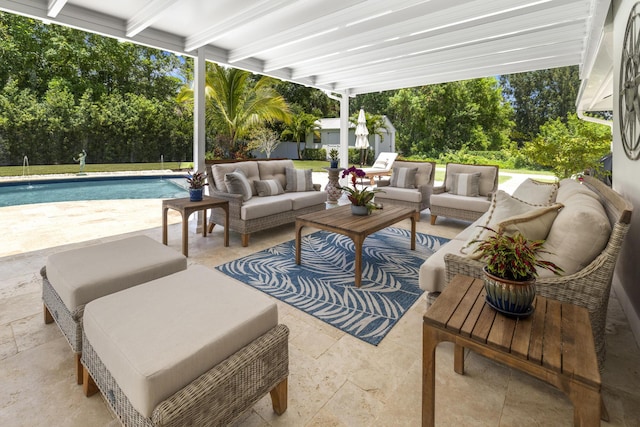 view of patio / terrace with outdoor lounge area, an outdoor pool, and view of scattered trees
