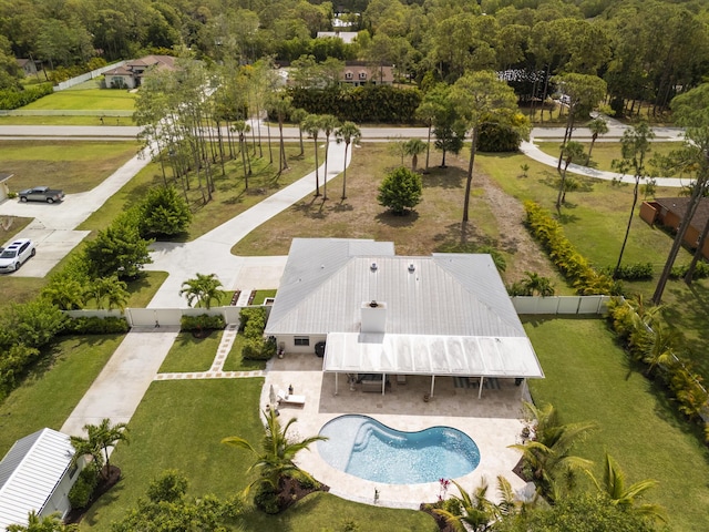 view of subject property with a pool