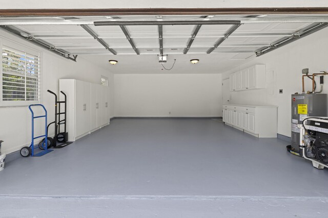 garage with electric water heater and a garage door opener