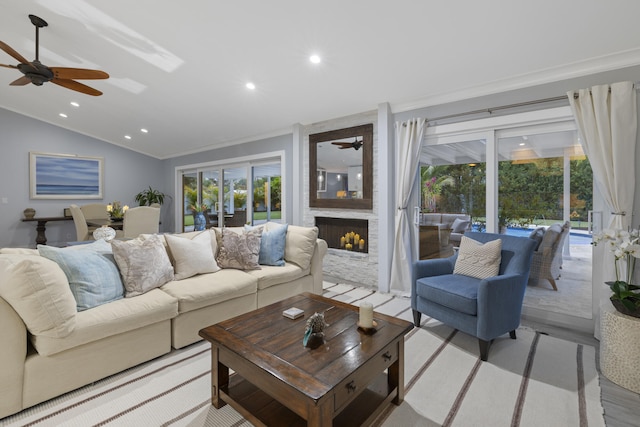 17767 Mellen Ln, Jupiter, FL 33478 - living room featuring ceiling fan, lofted ceiling, ornamental molding, recessed lighting, and a large fireplace