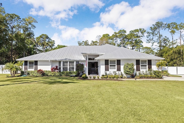 single story home featuring metal roof and stucco siding