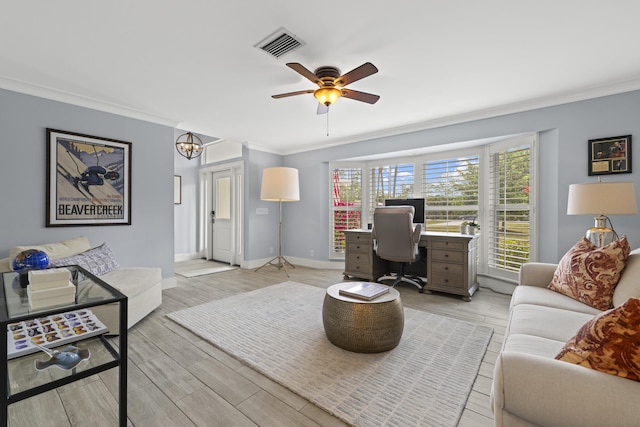 office space featuring crown molding, a ceiling fan, baseboards, and light wood-style flooring