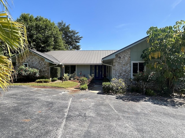 1614 SW Saint Andrews Dr, Palm City, FL 34990 - ranch-style house with stone siding and metal roof