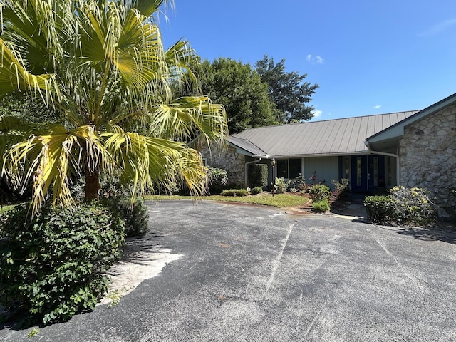 1614 SW Saint Andrews Dr, Palm City, FL 34990 - view of front of property with metal roof and stone siding