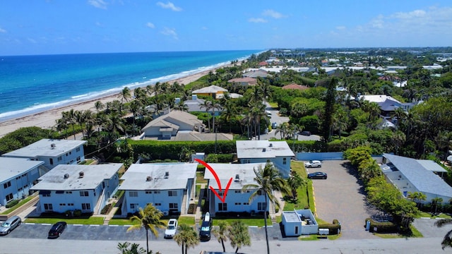 birds eye view of property featuring a beach view, a residential view, and a water view