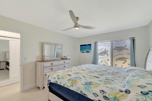 bedroom featuring a ceiling fan, baseboards, and light wood finished floors
