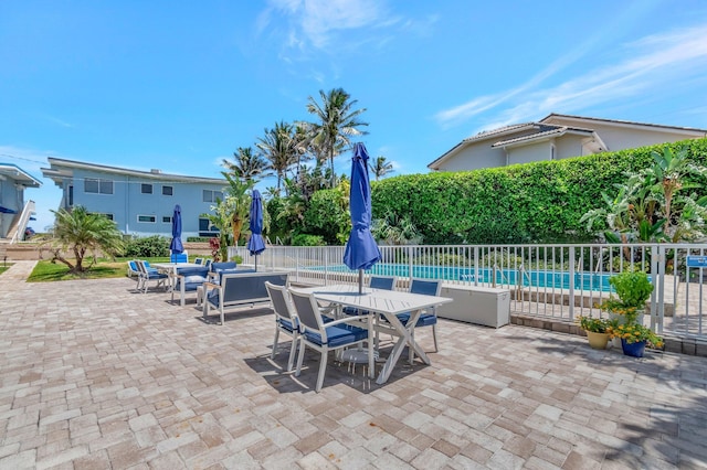 view of patio / terrace with fence, a fenced in pool, and outdoor dining space