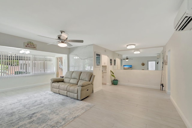 living area with an AC wall unit, baseboards, ceiling fan, and a wealth of natural light