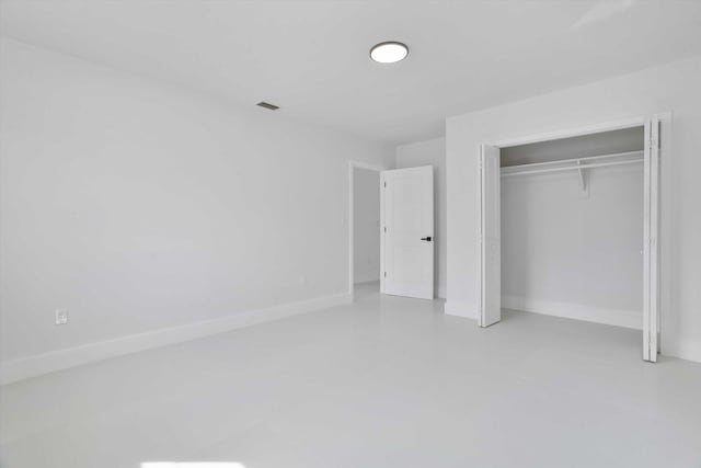 20685 NE 2nd Ave, Miami, FL 33179 - unfurnished bedroom featuring a closet, baseboards, concrete flooring, and visible vents