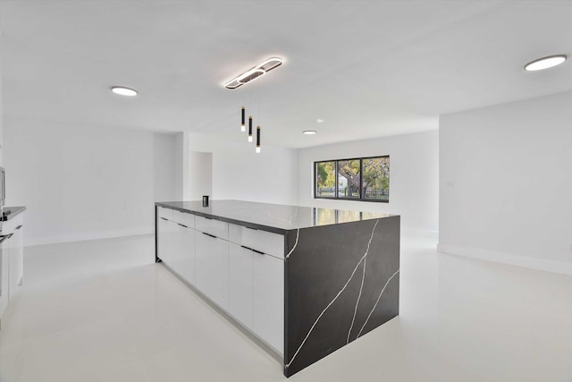 20685 NE 2nd Ave, Miami, FL 33179 - kitchen with dark countertops, modern cabinets, recessed lighting, white cabinets, and light tile patterned floors