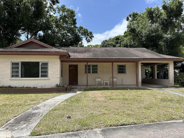 1507 Edgevale Rd, Fort Pierce, FL 34982 - ranch-style house with a shingled roof, a front yard, and a carport