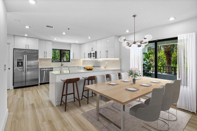 15687 Loch Maree Ln Unit 2404, Delray Beach, FL 33446 - dining room with a chandelier, light wood finished floors, and recessed lighting