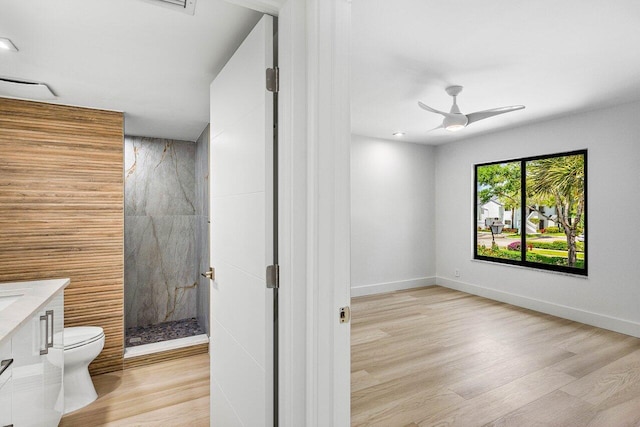 15687 Loch Maree Ln Unit 2404, Delray Beach, FL 33446 - full bathroom featuring toilet, a marble finish shower, wood finished floors, vanity, and a ceiling fan