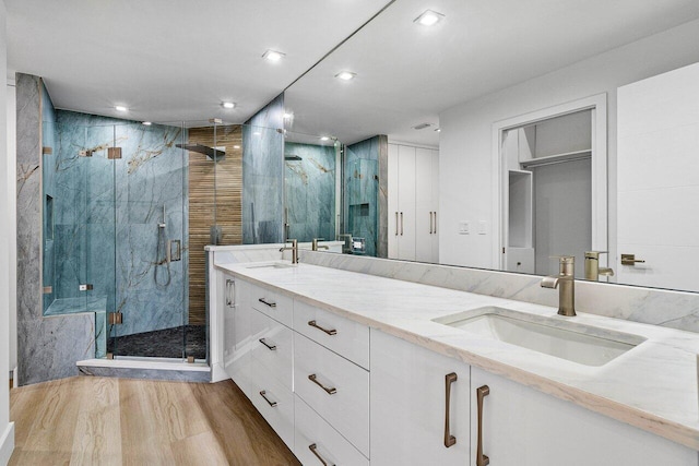 15687 Loch Maree Ln Unit 2404, Delray Beach, FL 33446 - bathroom with a marble finish shower, wood finished floors, double vanity, and recessed lighting