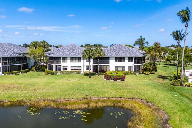 15687 Loch Maree Ln Unit 2404, Delray Beach, FL 33446 - rear view of property with a water view, roof with shingles, a yard, and stucco siding