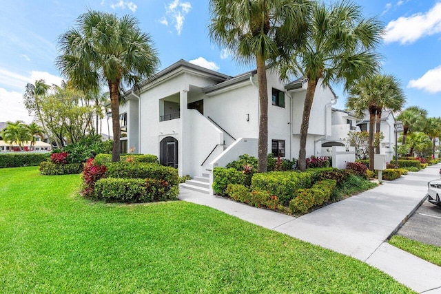 15687 Loch Maree Ln Unit 2404, Delray Beach, FL 33446 - view of front of property with stucco siding and a front lawn