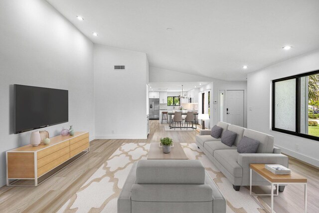 15687 Loch Maree Ln Unit 2404, Delray Beach, FL 33446 - living room featuring vaulted ceiling, light wood-type flooring, recessed lighting, and baseboards