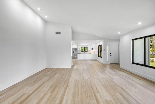 15687 Loch Maree Ln Unit 2404, Delray Beach, FL 33446 - unfurnished living room with lofted ceiling, light wood-style floors, recessed lighting, and baseboards