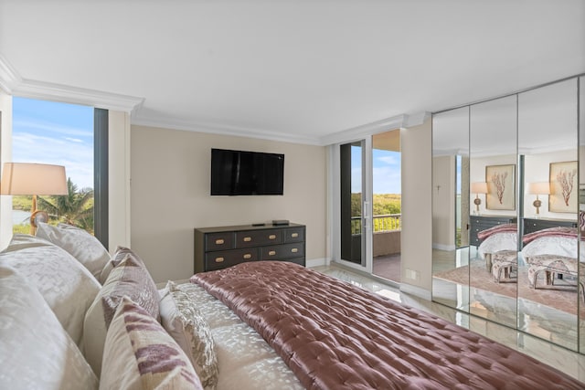 bedroom with baseboards, ornamental molding, access to exterior, and a wall of windows