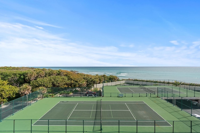 view of sport court with a water view, fence, and community basketball court