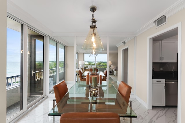dining room featuring crown molding, visible vents, and a healthy amount of sunlight