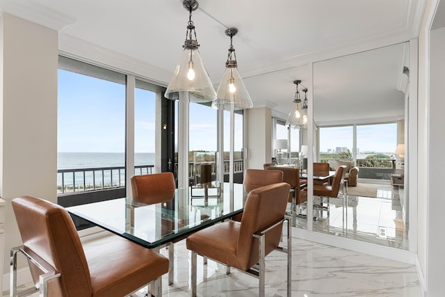 dining area featuring crown molding, a water view, and marble finish floor