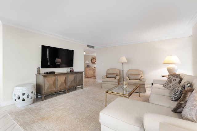 living room with crown molding, baseboards, and visible vents
