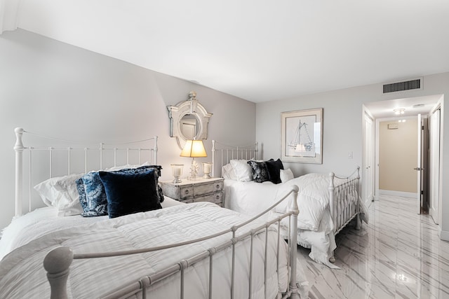 bedroom with visible vents and marble finish floor