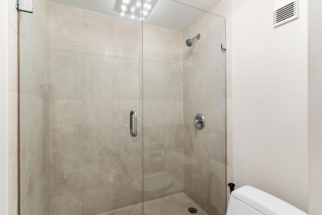 full bath with visible vents, toilet, and a shower stall