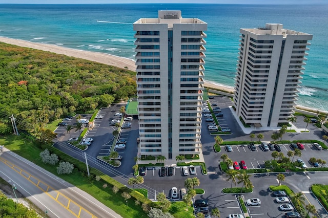 drone / aerial view with a beach view and a water view