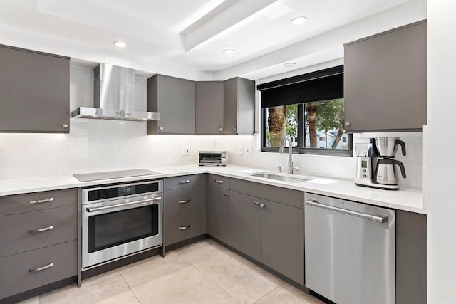 15702 Loch Maree Ln Unit 5804, Delray Beach, FL 33446 - kitchen with stainless steel appliances, wall chimney range hood, gray cabinets, a sink, and backsplash