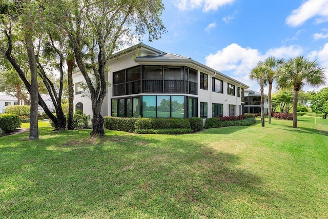 15702 Loch Maree Ln Unit 5804, Delray Beach, FL 33446 - back of property featuring a sunroom, a yard, and stucco siding
