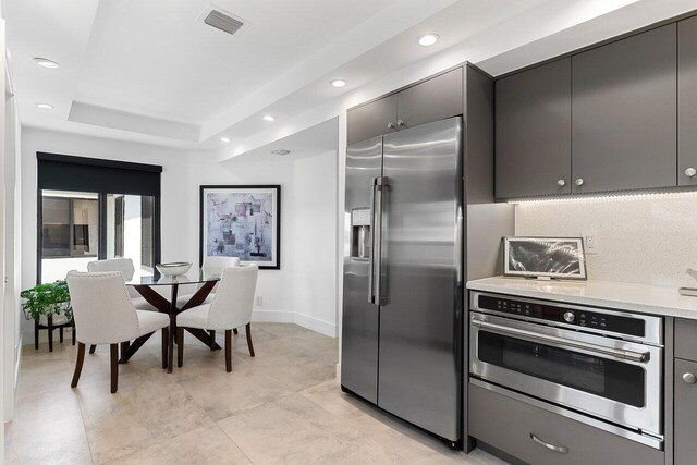 15702 Loch Maree Ln Unit 5804, Delray Beach, FL 33446 - kitchen with appliances with stainless steel finishes, light countertops, recessed lighting, a raised ceiling, and baseboards