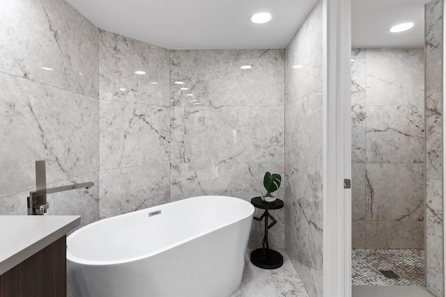 15702 Loch Maree Ln Unit 5804, Delray Beach, FL 33446 - bathroom with tile walls, a freestanding tub, vanity, and recessed lighting