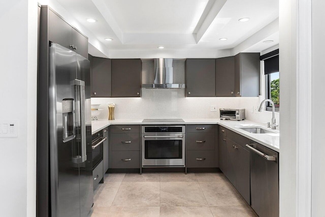 15702 Loch Maree Ln Unit 5804, Delray Beach, FL 33446 - kitchen with wall chimney exhaust hood, appliances with stainless steel finishes, a sink, a raised ceiling, and light countertops