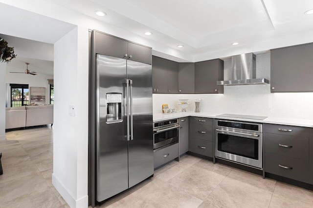 15702 Loch Maree Ln Unit 5804, Delray Beach, FL 33446 - kitchen featuring stainless steel appliances, wall chimney range hood, ceiling fan, light countertops, and recessed lighting