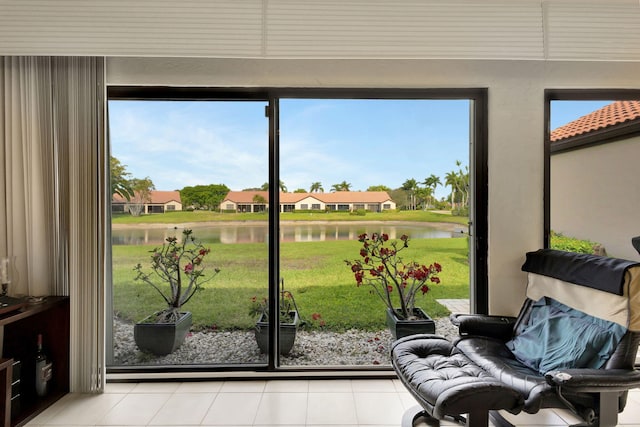 entryway with a residential view, a water view, and light tile patterned floors