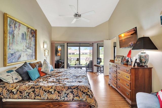 bedroom with light wood-style floors, high vaulted ceiling, access to outside, and a ceiling fan