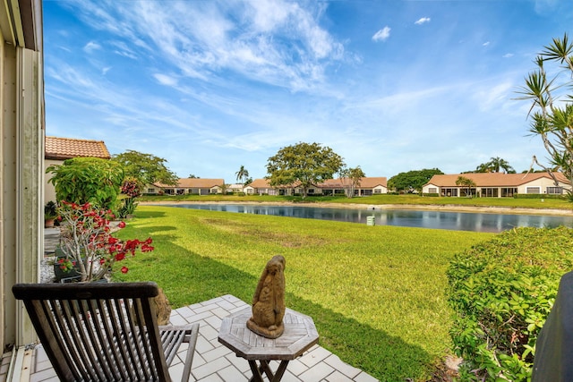 view of yard with a water view, a residential view, and a patio area