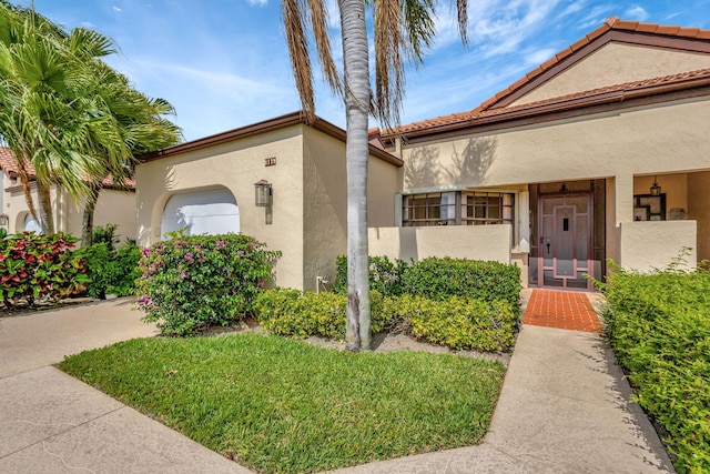 mediterranean / spanish-style home with a garage and stucco siding