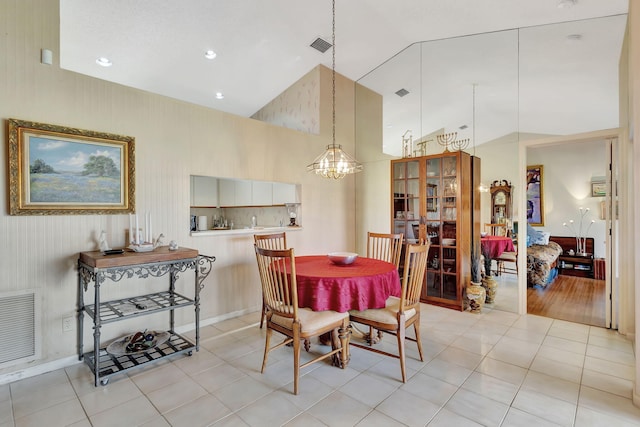 dining space with visible vents, light tile patterned floors, high vaulted ceiling, an inviting chandelier, and recessed lighting